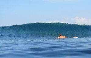 big wave starting to form with one surfer watching in nusa lembongan